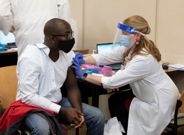 Dr. Oppong getting the COVID vaccine