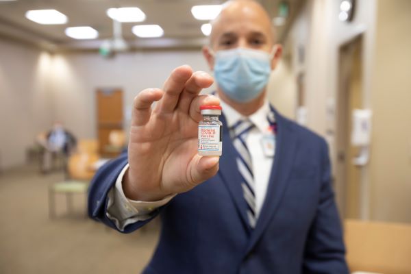 man holding the vaccine vial