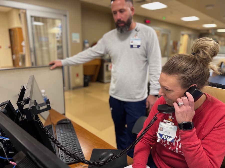 two people work in the Emergency Room answering phones
