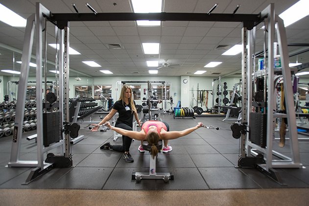 Member and trainer using Healthpark exercise equipment