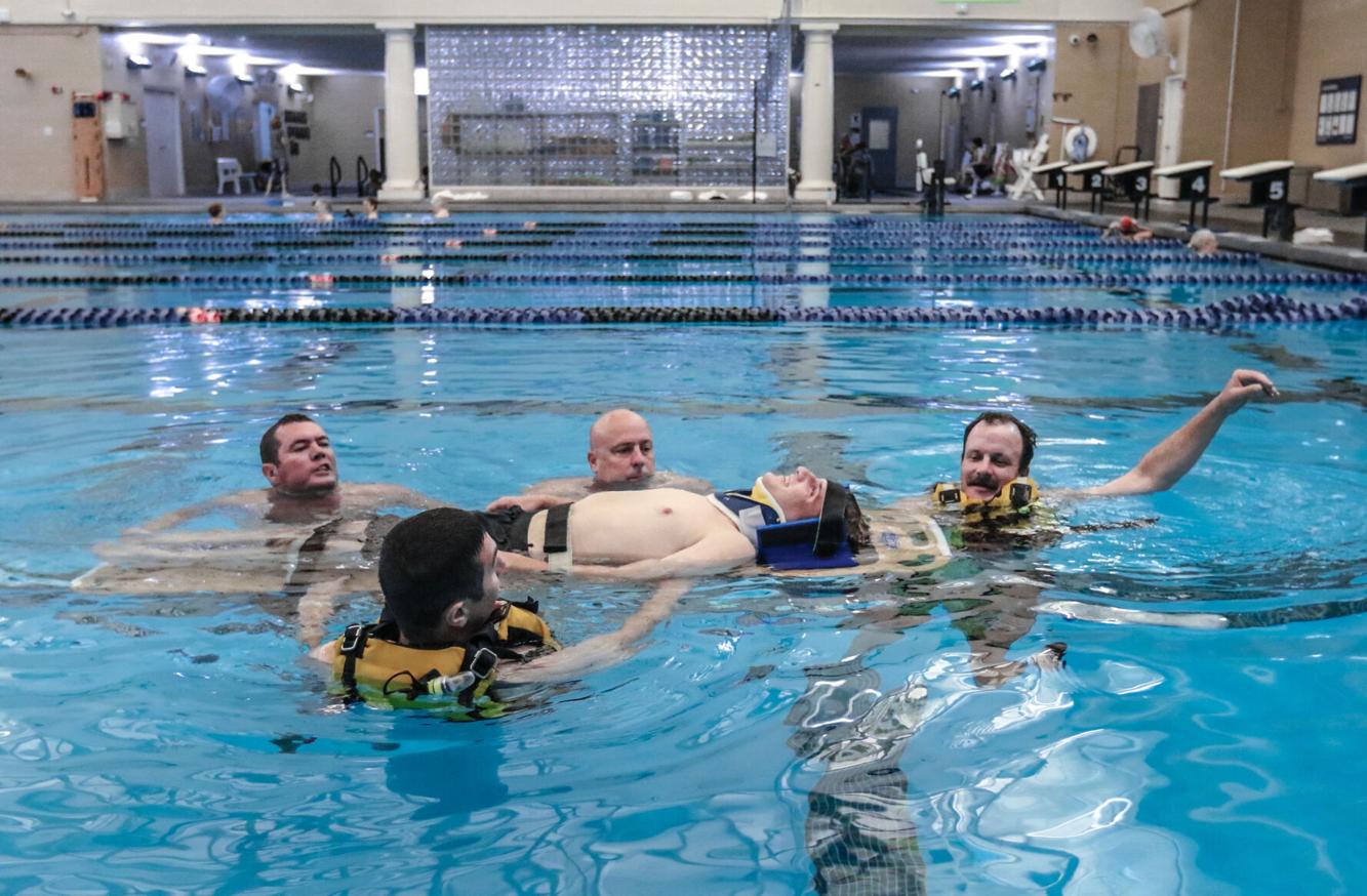 fire department conducting drill in pool