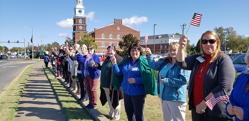 team members waving flags