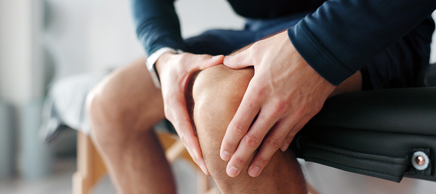 person holding their sore knee