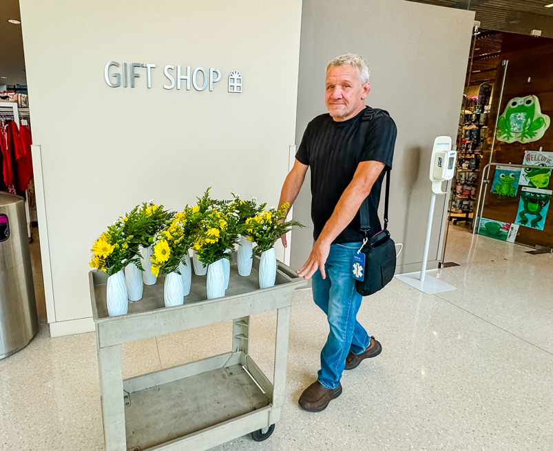 man pushing flower cart