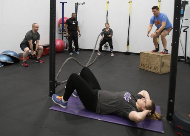 people exercising in the rogue room