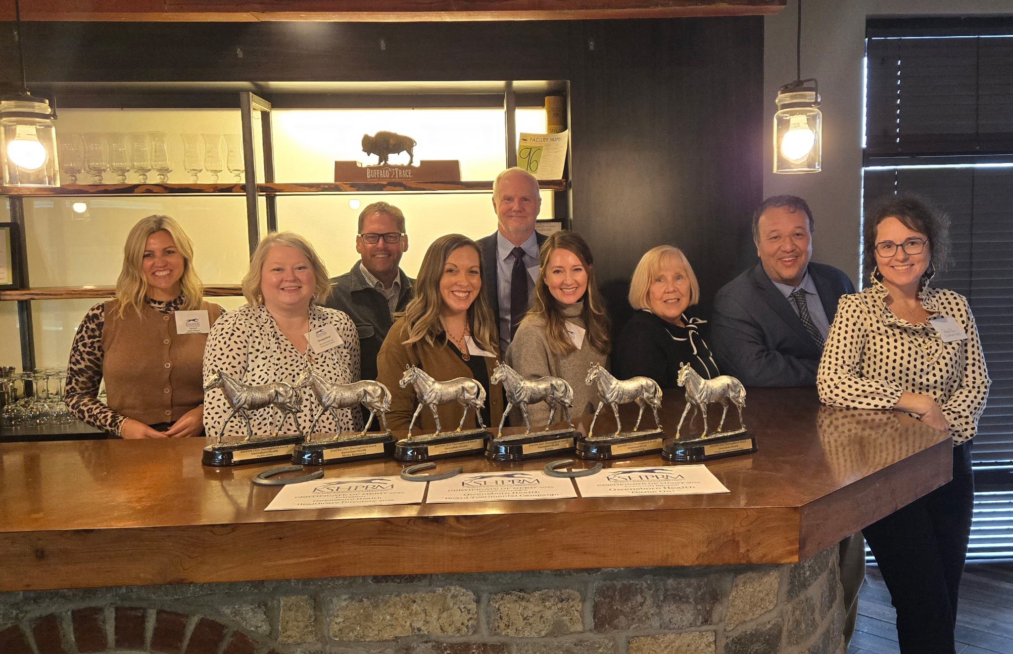 group of 9 people with 9 awards