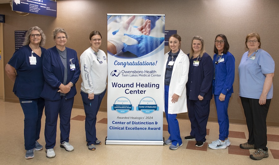 a group of 15 people pose for a photo