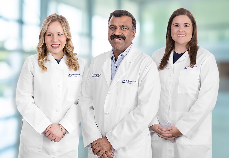 three healthcare providers in white coats