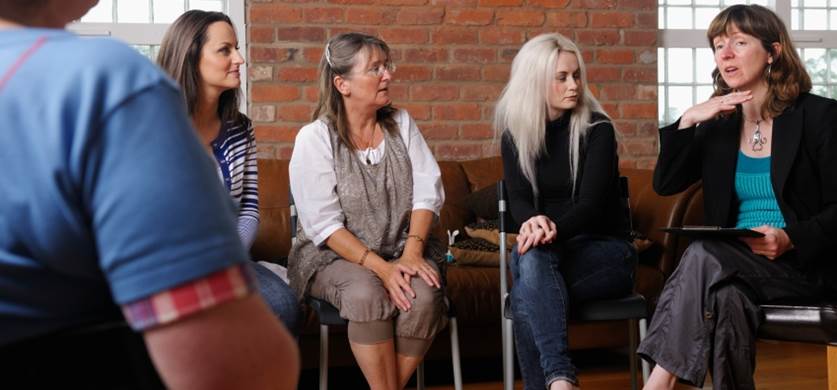 Group of people gathered in a support group