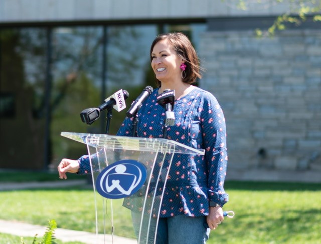 Coleman speaking at podium