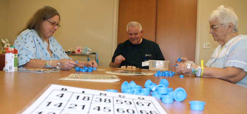 people playing bingo at a table