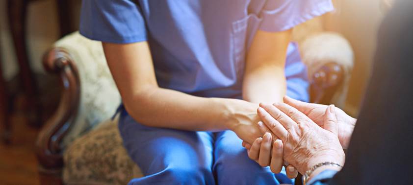 caregiver holding hands with patient