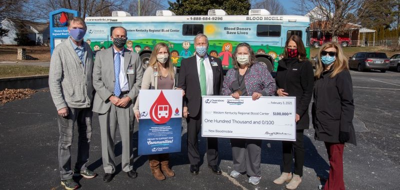 group in front of bloodmobile