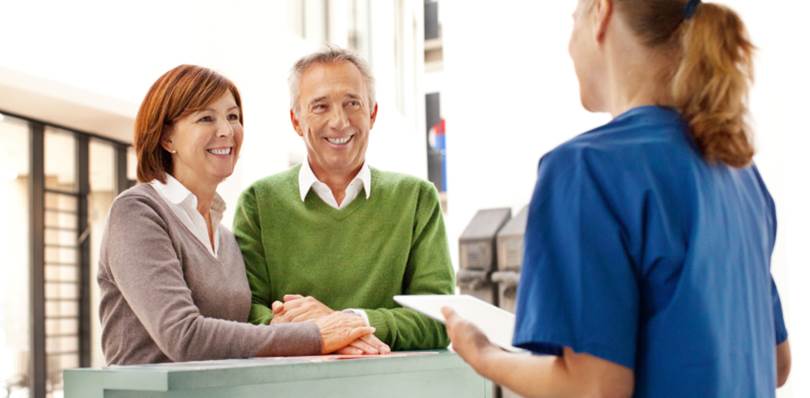 happy couple talking to provider