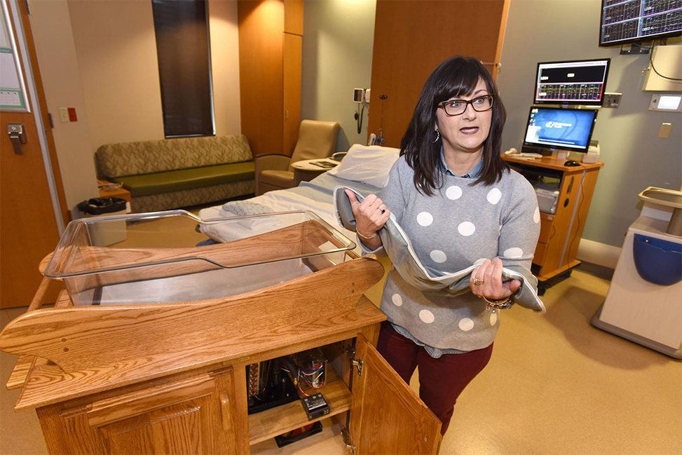 owensboro health team members holds cooling pad next to smart cradle