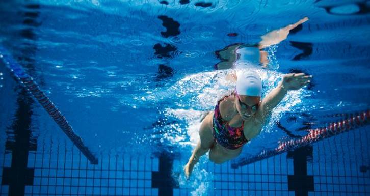 Woman doing laps in a pool