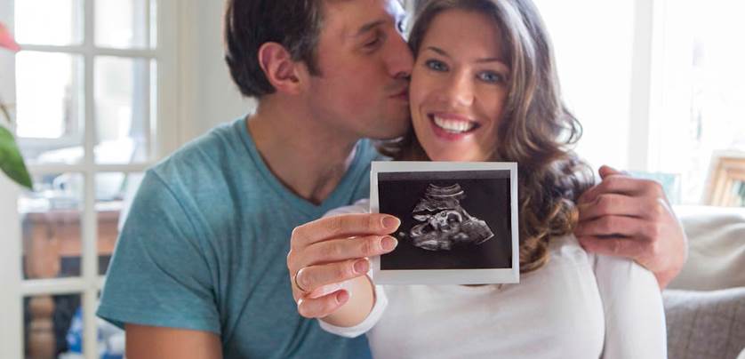 couple holding an ultrasound image