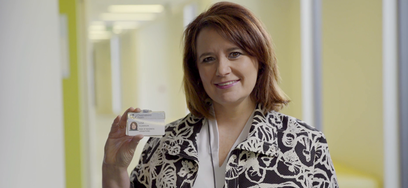 Woman holding employee badge