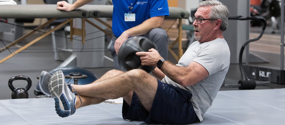 man exercising with medicine ball