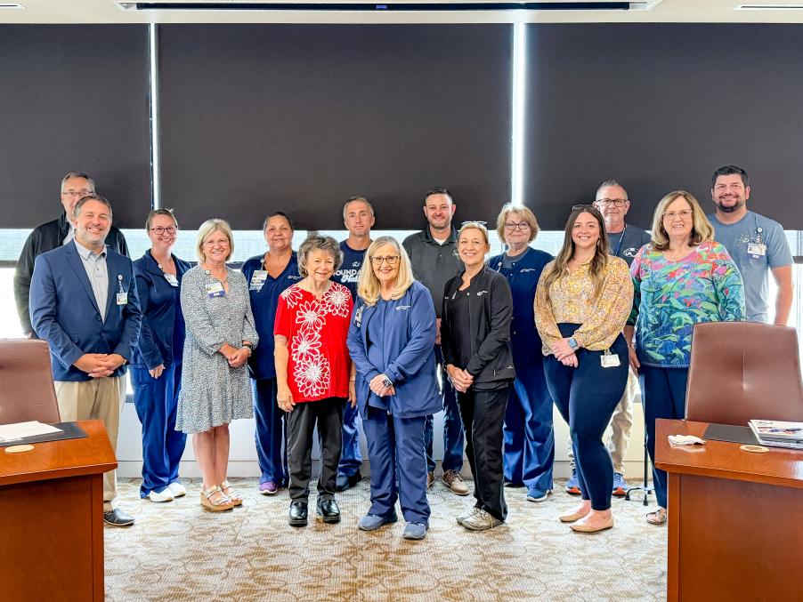a group of 15 people pose for a photo