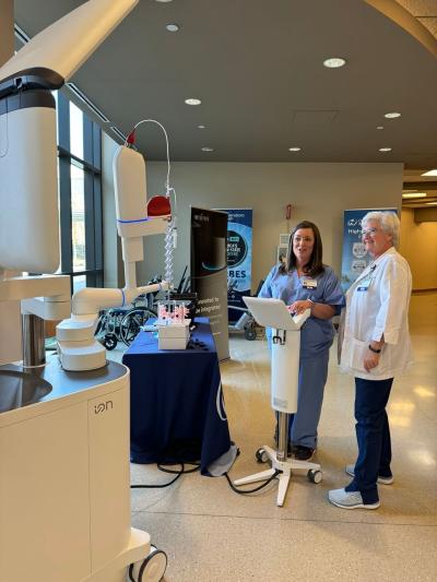 Healthcare workers operate a diagnostic robot