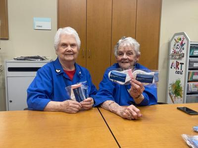 women holding newborn socks