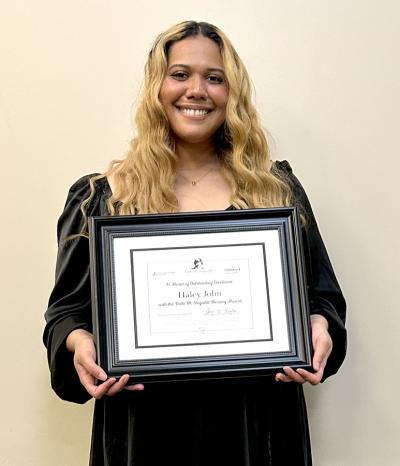 girl in black dress holding certificate