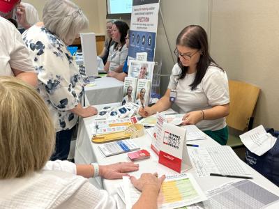 woman getting her blood pressure read at an exhibit table