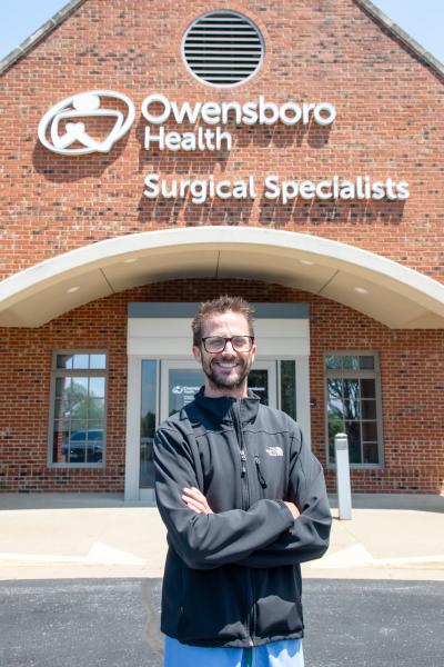 a doctor stands outside his office