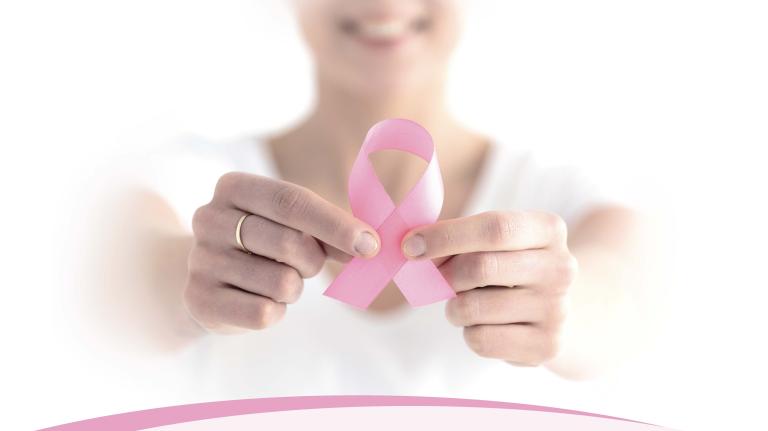 woman holding a pink ribbon