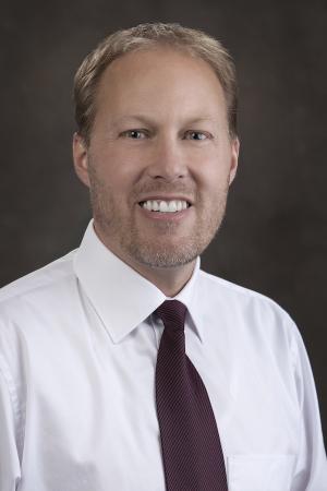 blonde man in white shirt and red tie