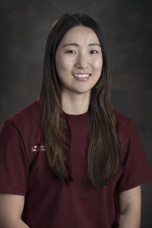 brunette woman in maroon shirt