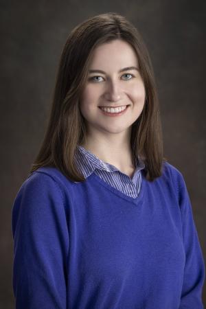 brunette woman in blue sweater