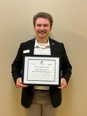 Young man holds an award certificate
