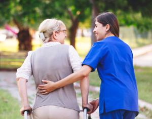 patient and nurse walking outdoors